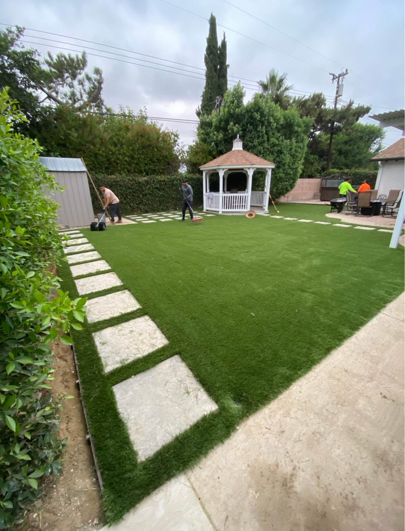 Finished turf lawn with stepping-stone border and gazebo